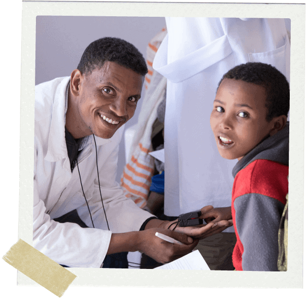 Doctor and young boy looking at the camera