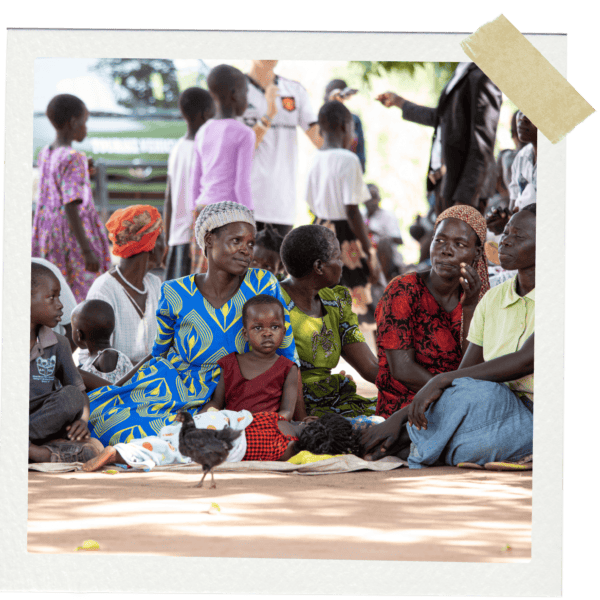Women and children sitting on the ground