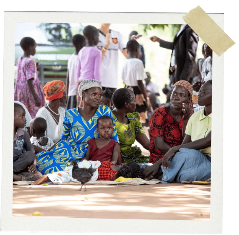 Women and children sitting on the ground