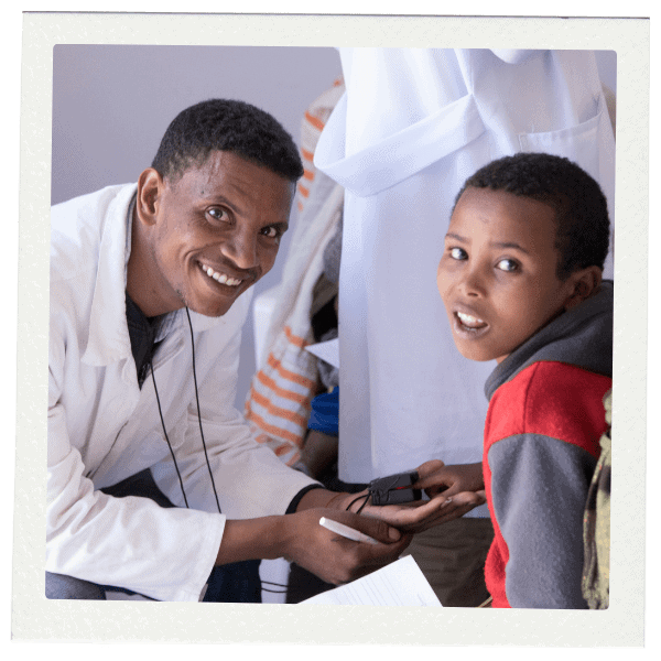 Doctor smiling at young boy patient