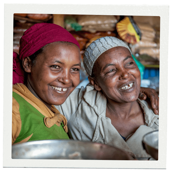 Women embracing and smiling