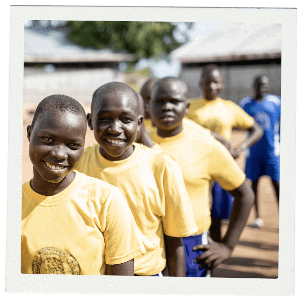 Line of smiling teens in sport uniforms